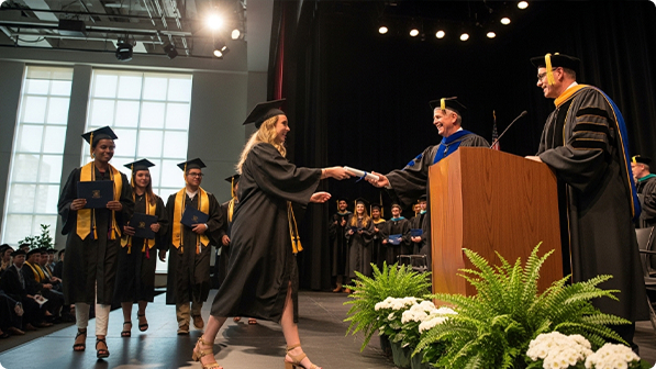 Graduation ceremony with students receiving diplomas